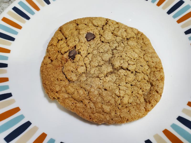 A closeup of Good Hope Bakery Gluten-Free Chocolate Chip Cookie with only two visible chocolate chips